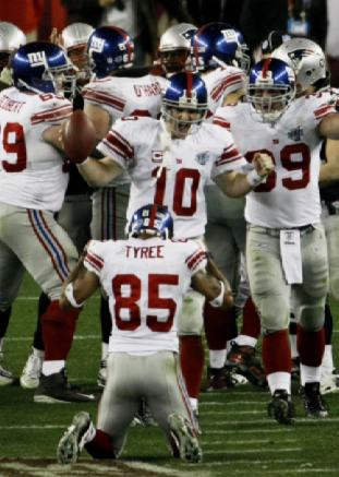 Super Bowl XLII GLENDALE, AZ - FEBRUARY 03: Quarterback Eli Manning #10 of the New York Giants celebrates their 17-14 victory against the New England Patriots during Super Bowl XLII on February 3, 2008 at the University of Phoenix Stadium in Glendale, Arizona. (Photo by Win McNamee/Getty Images)