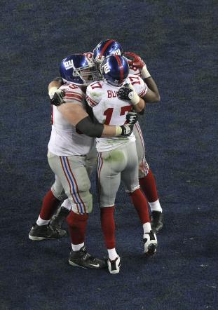 Super Bowl XLII GLENDALE, AZ - FEBRUARY 03: Wide receiver Plaxico Burress #17 of the New York Giants celebrates after catching a 13-yard touchdown pass in the fourth quarter with teammates David Diehl #66 and Rich Seubert #69 during Super Bowl XLII on February 3, 2008 at the University of Phoenix Stadium in Glendale, Arizona. (Photo by Doug Pensinger/Getty Images)