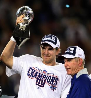 MVP Eli Manning of the New York Giants and coach Tom Coughlin celebrate after defeating the New England Patriots in Super Bowl XLII at the University of Phoenix Stadium in Glendale, Arizona 03 February 2008. The Giants won 17-14. AFP PHOTO/Timothy A. CLARY (Photo credit should read TIMOTHY A. CLARY/AFP/Getty Images)