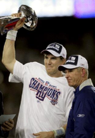 MVP Eli Manning of the New York Giants and coach Tom Coughlin together with the Lombardi Trophy